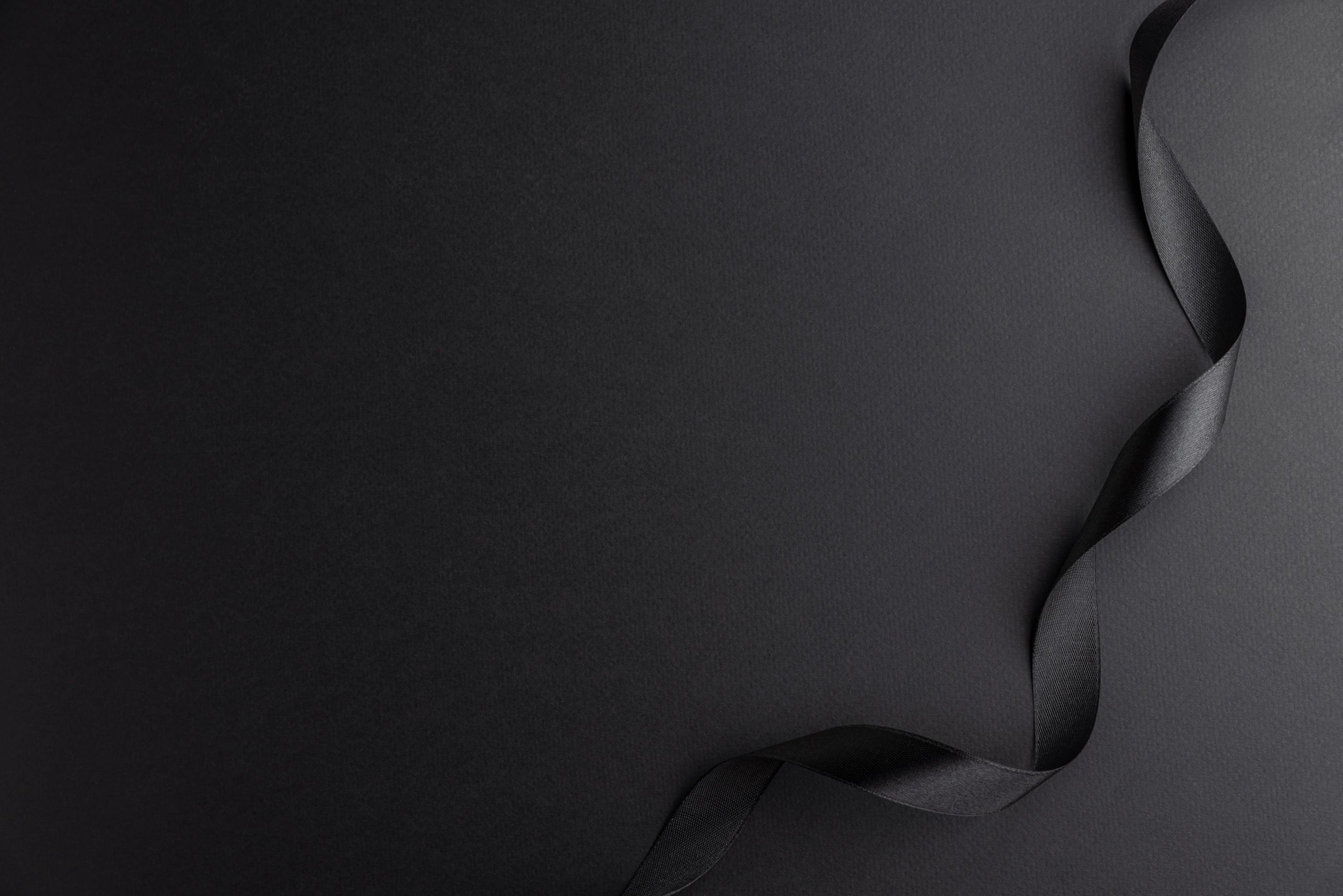 Black satin ribbon on dark background